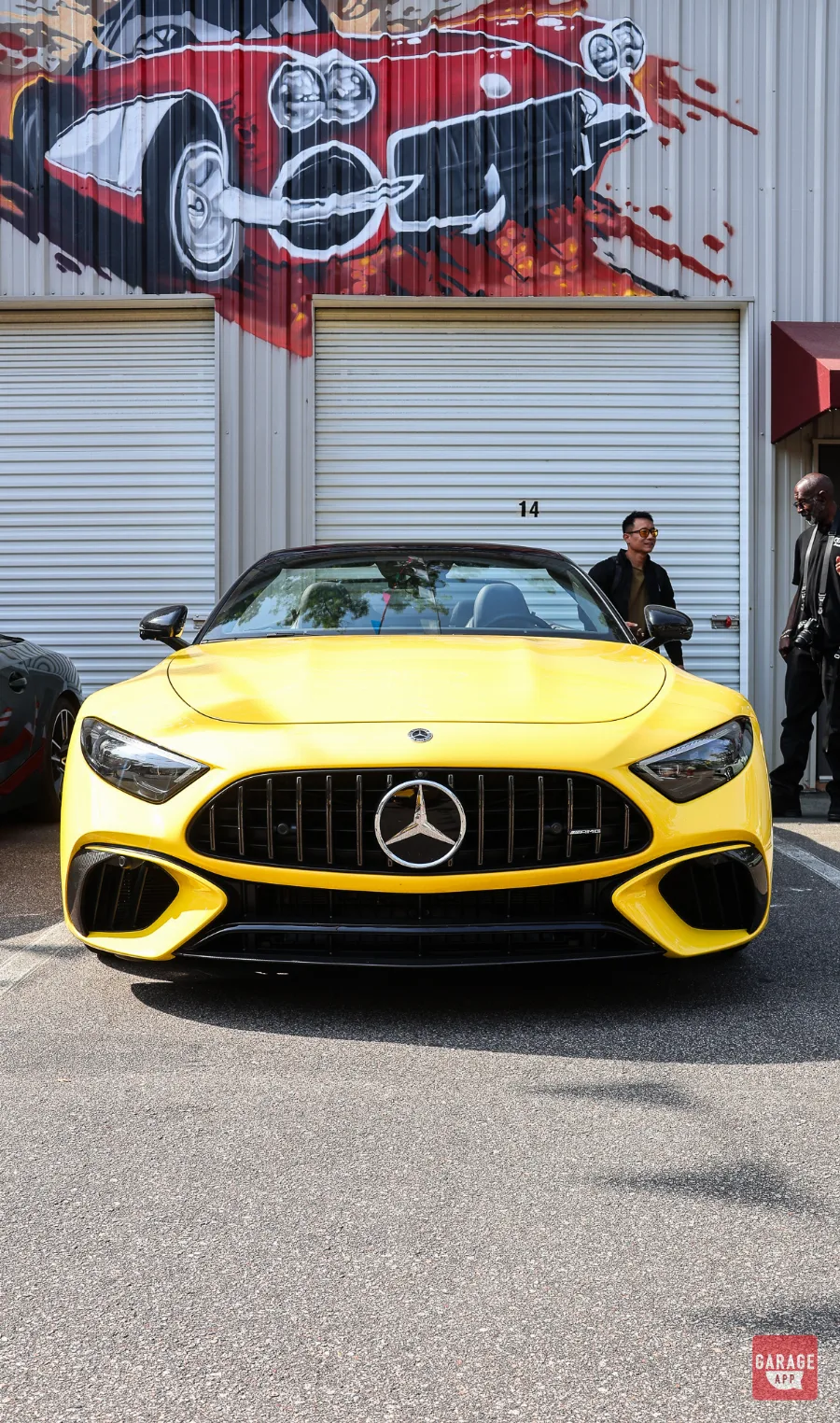 Front view of a 2025 Mercedes-AMG SL 63 in MANUFAKTUR Sun Yellow featuring the signature AMG Panamericana grille and modern LED headlights.
