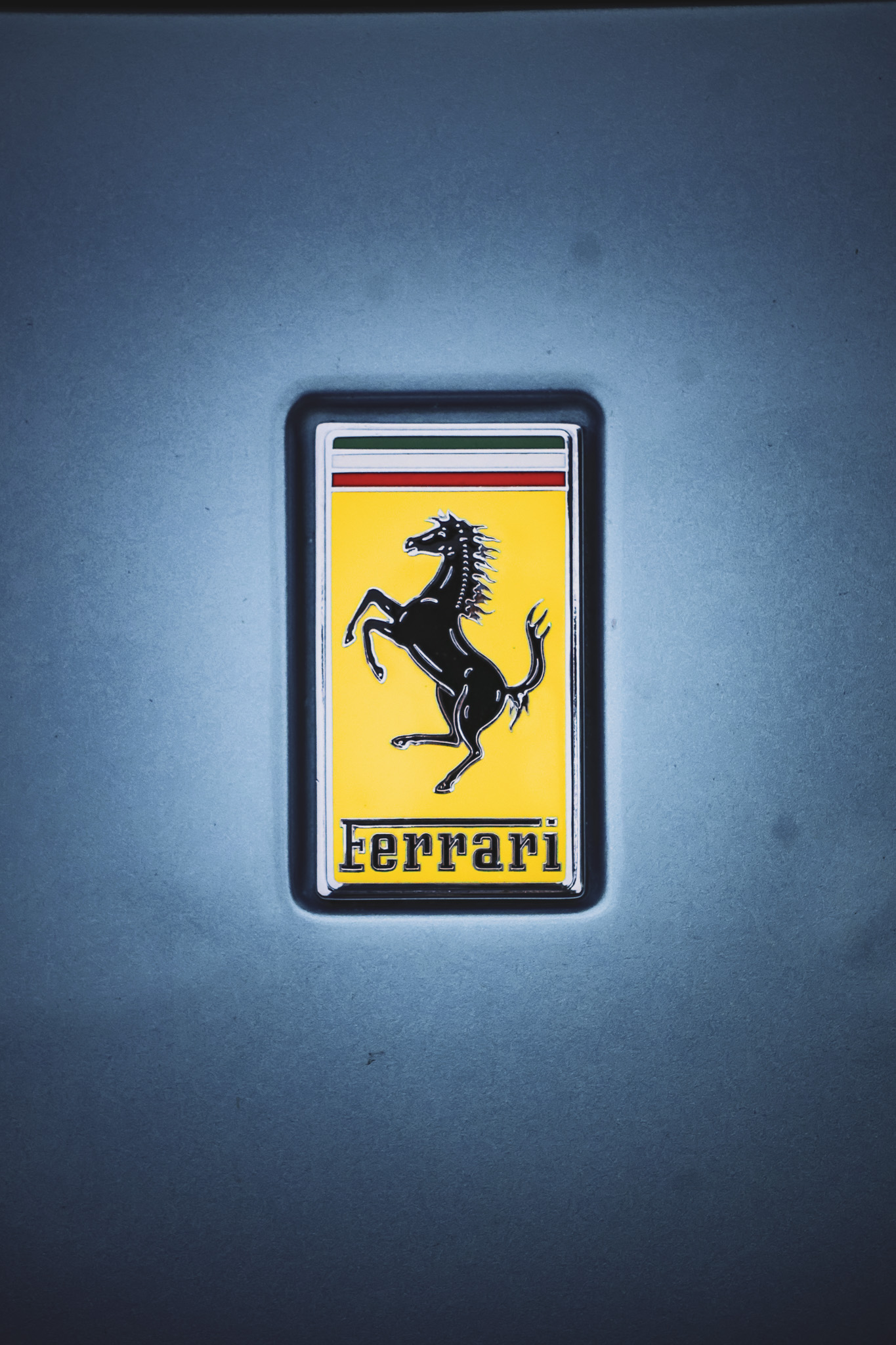 The iconic Ferrari prancing horse badge mounted on the side fender of this Ferrari Portofino.