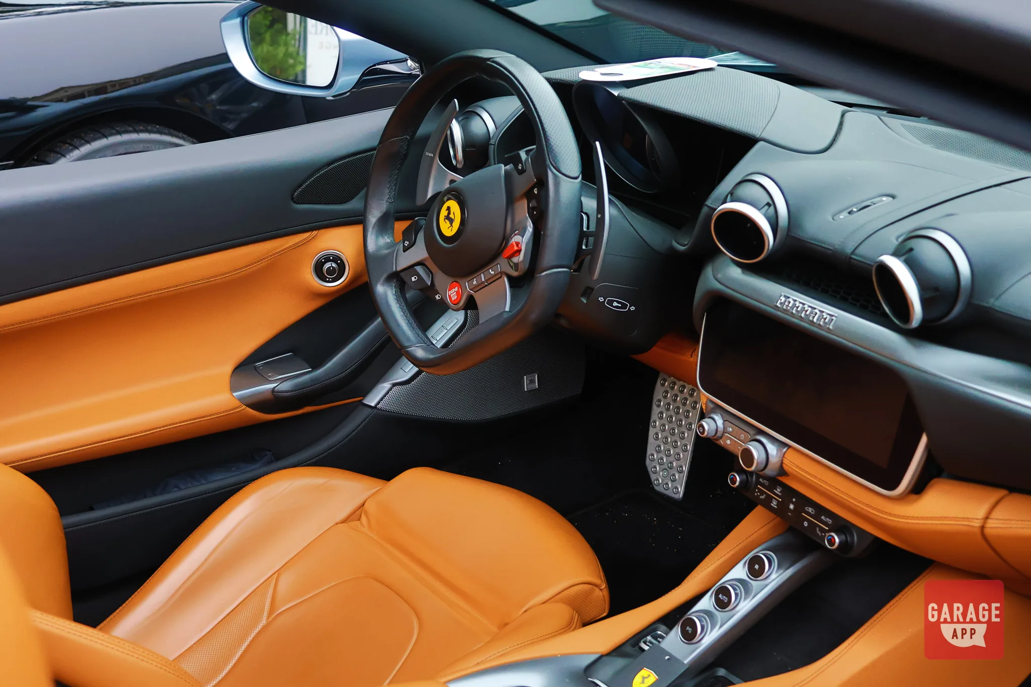 Open-top Ferrari Portofino parked outdoors, showcasing the convertible configuration and luxurious interior.