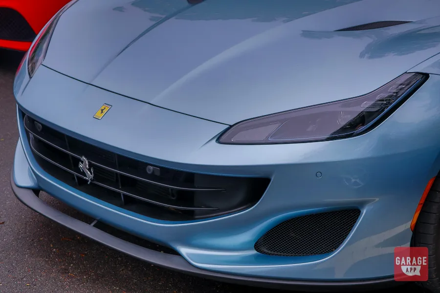 Front corner shot of a 2019 Ferrari Portofino emphasizing the aerodynamic lines and luxury sports car proportions.