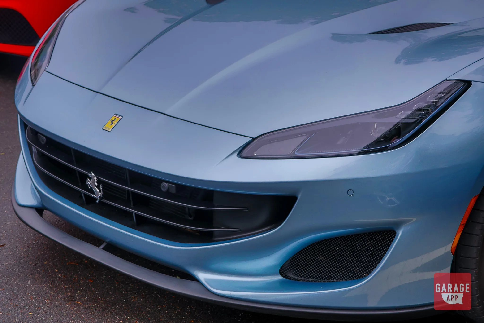 Front corner shot of a 2019 Ferrari Portofino emphasizing the aerodynamic lines and luxury sports car proportions.