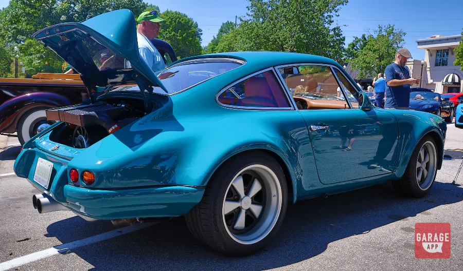 Rear three-quarter photograph of a Singer Porsche 911 with wide rear fenders and iconic 911 proportions.