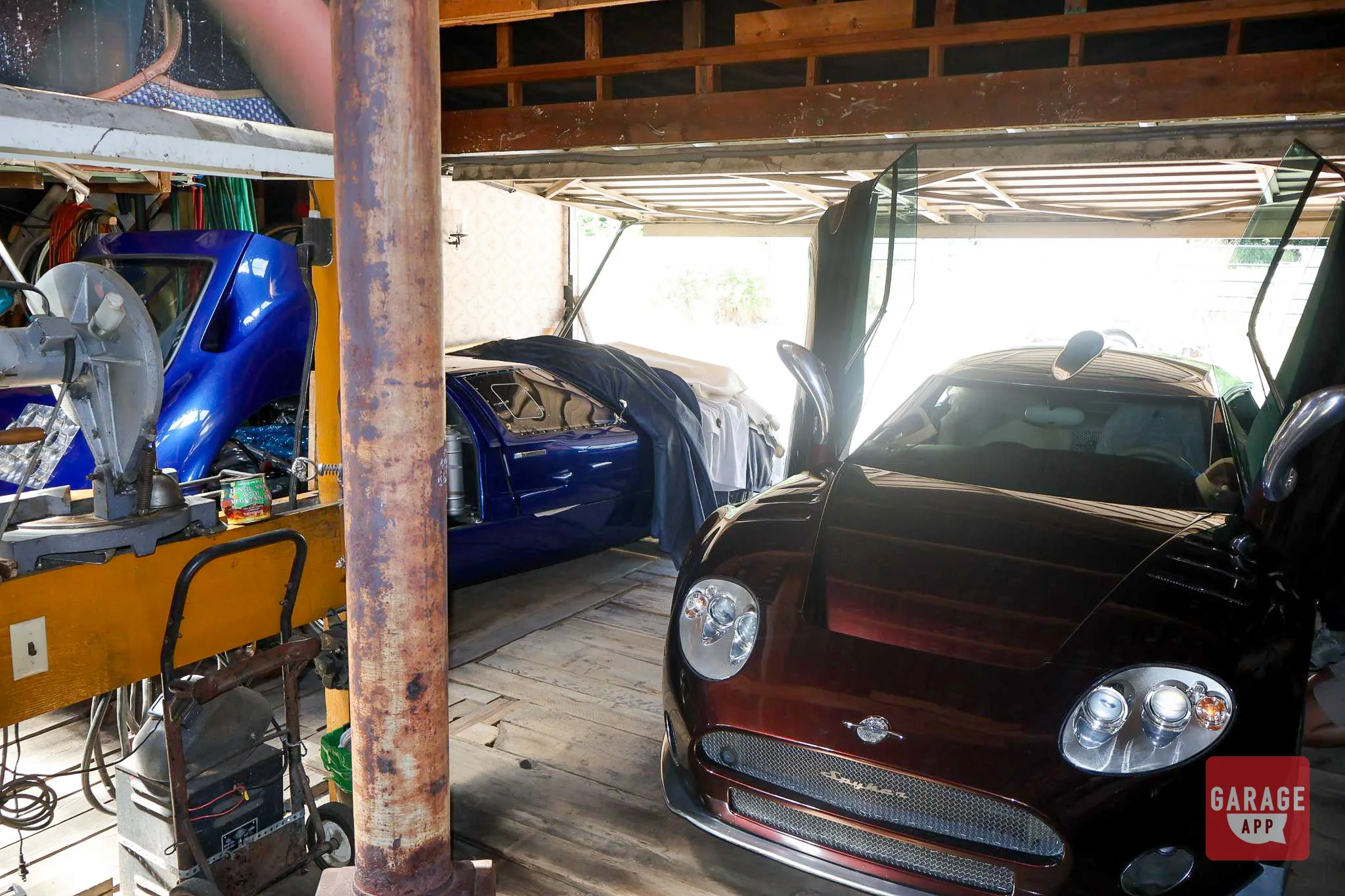 Inside the barn — the Spyker squeezed in among other vehicles