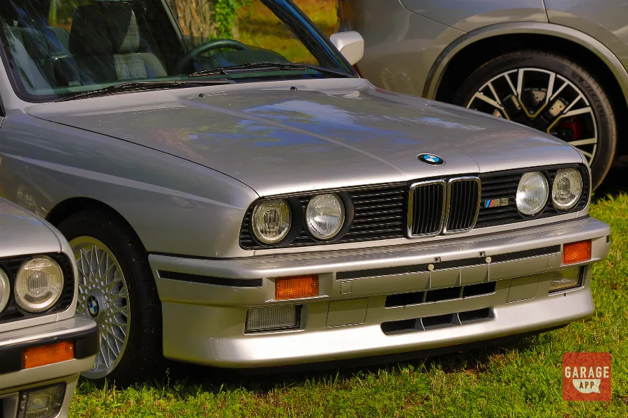 Original BMW E30 M3 displayed at a classic BMW event showcasing the legendary motorsport-inspired sports coupe.