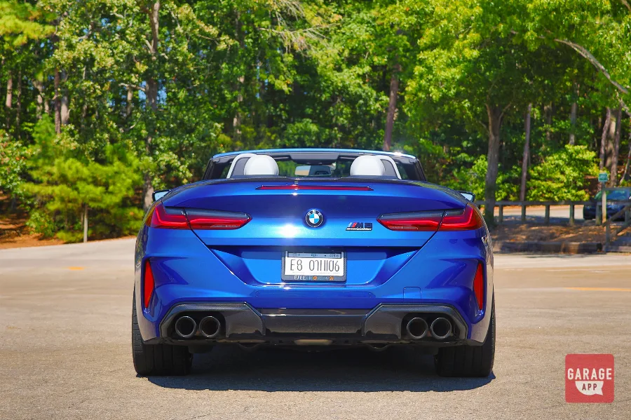 Rear view of blue BMW M8 Competition Convertible showing quad exhaust tips