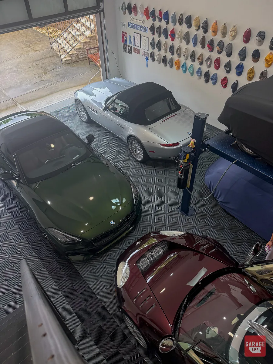 Silver BMW Z8, green Z4, and burgundy classic parked in private collector garage