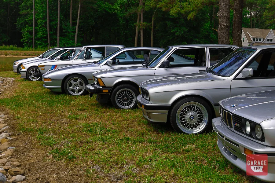 Classic BMW E24 and E30 models displayed along a lakeside at Europäisch.