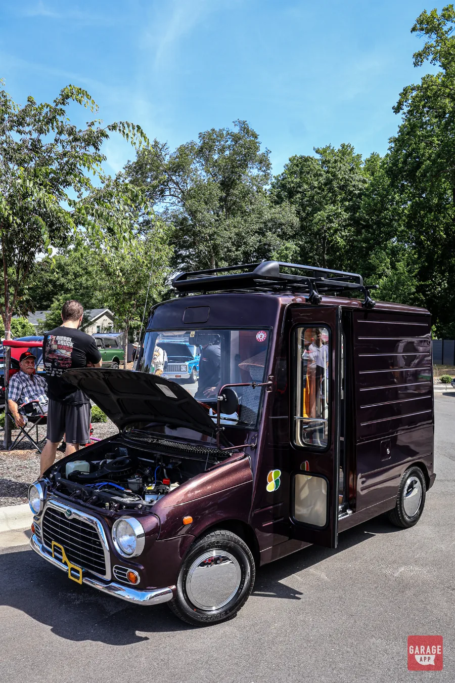 Custom classic Mini panel van displayed with its hood open at Fuquay-Varina Cars and Coffee.