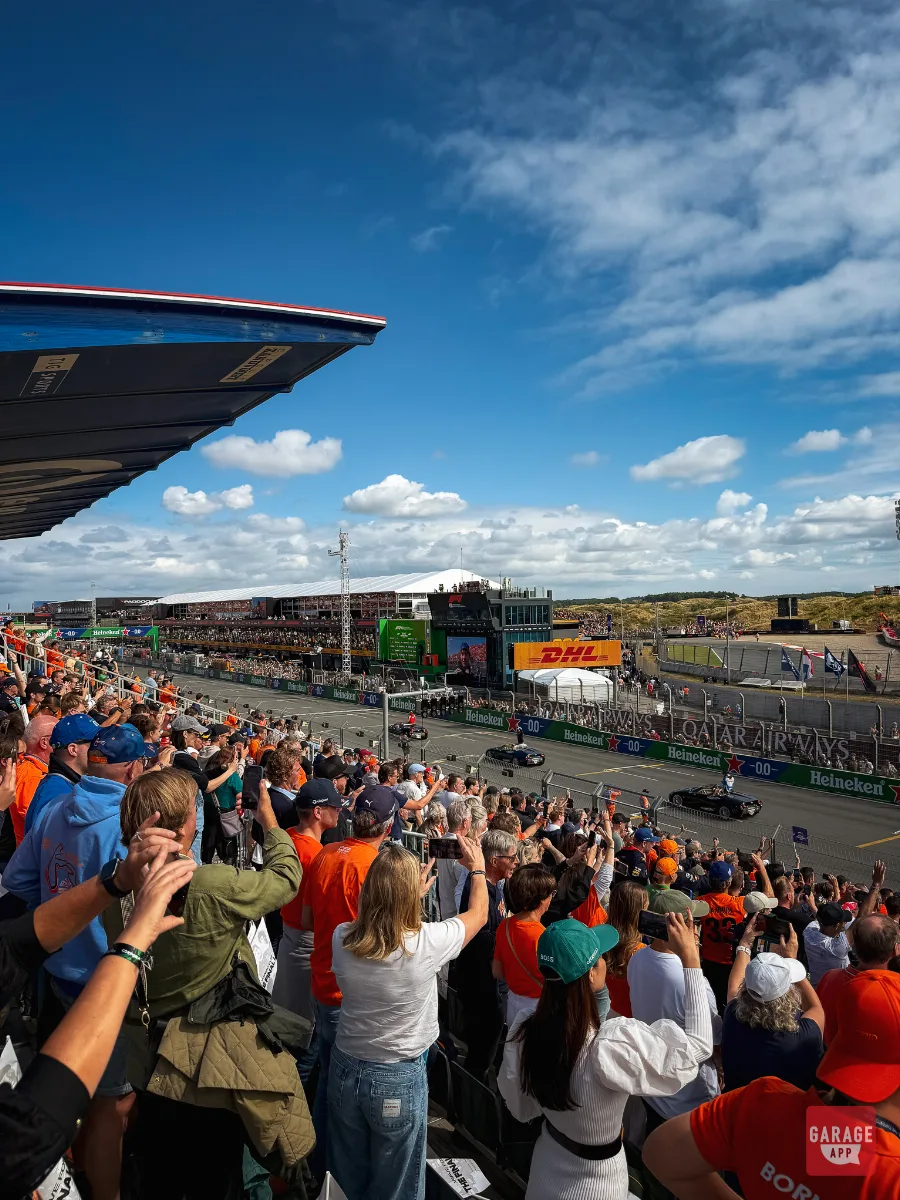Crowd watching Spyker C8 parade cars from grandstand at Zandvoort F1 Drivers' Parade