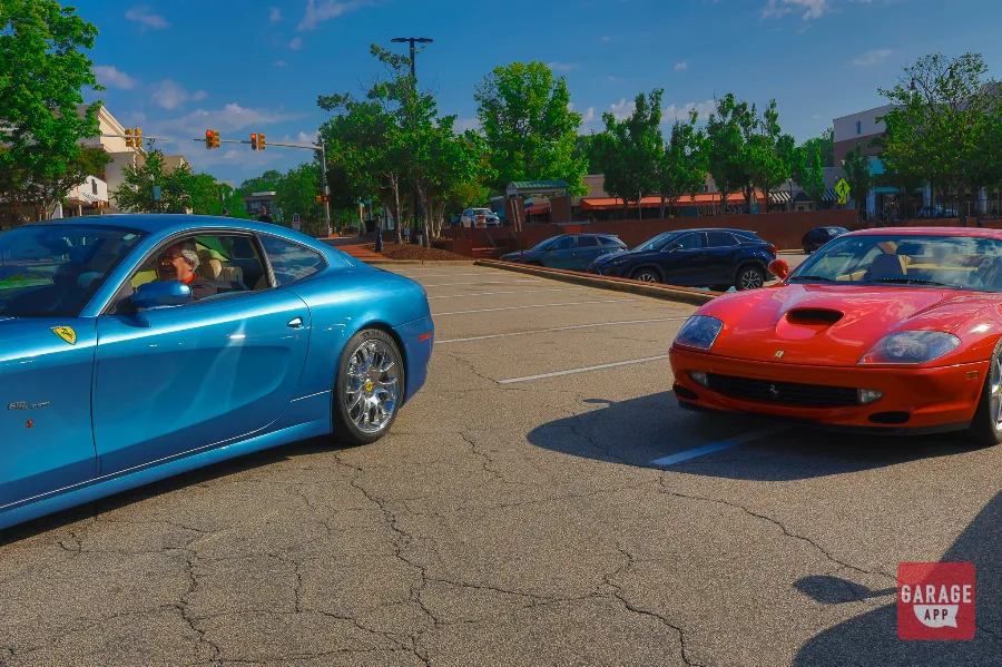 Blue Ferrari 612 Scaglietti and red Ferrari 550 Maranello parked front to front on street