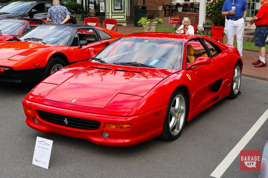 Red Ferrari F355 Berlinetta displayed at a North Carolina car show in front three-quarter view.