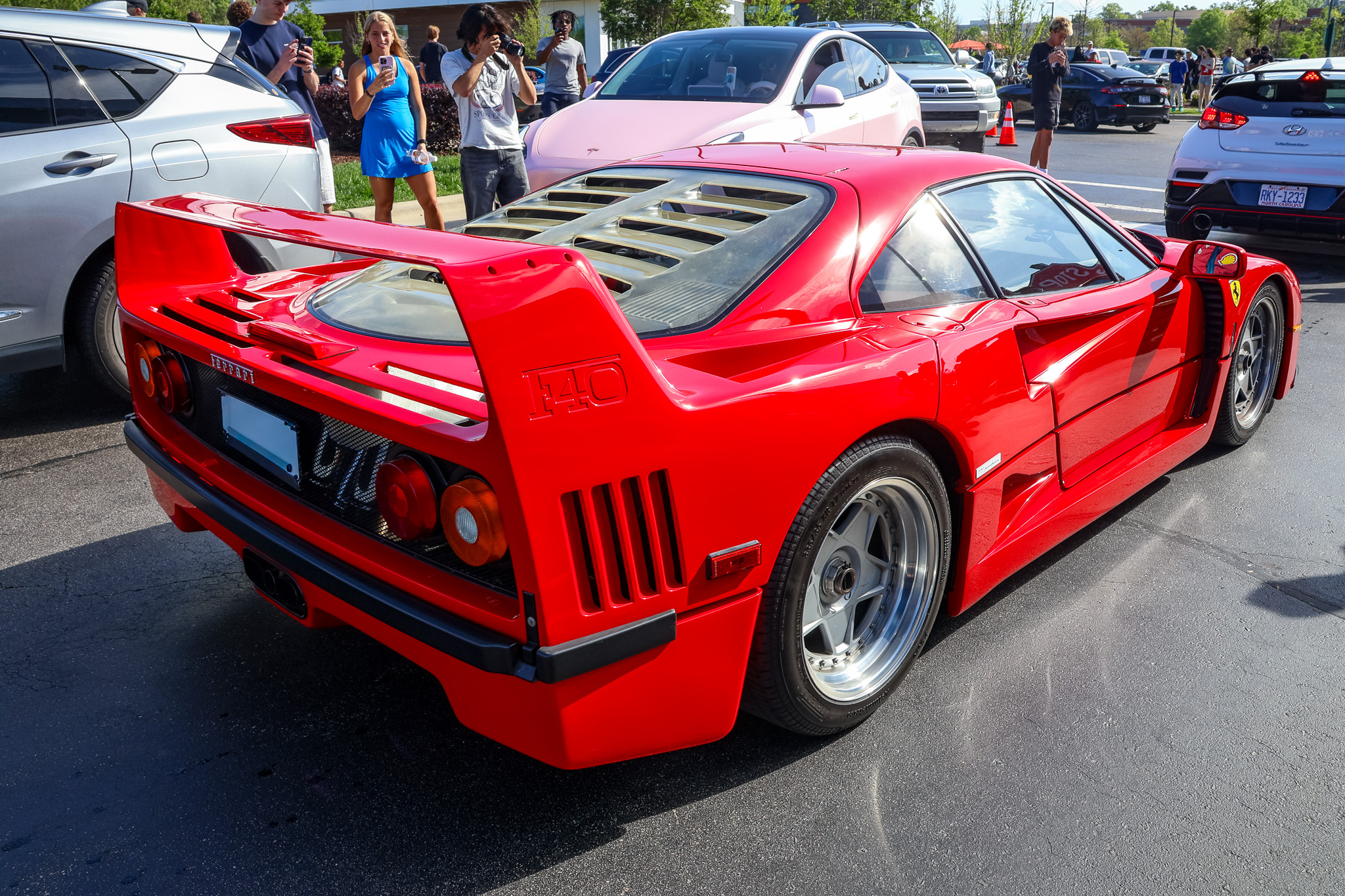 Red Ferrari F40 rear three-quarter view with engine louvers