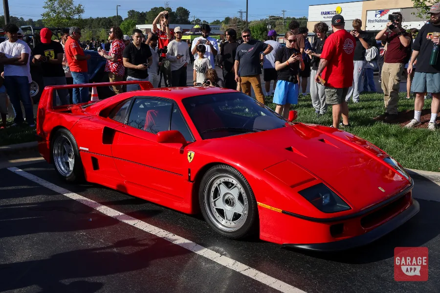 Red Ferrari F40 front quarter view surrounded by crowd