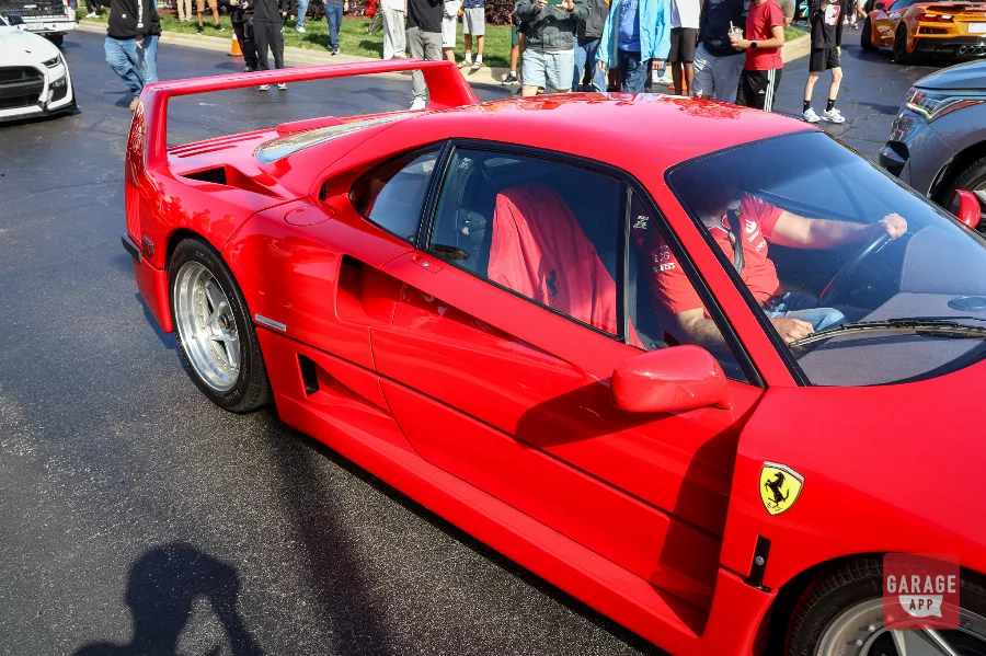 Ferrari F40 side profile view with driver visible in seat