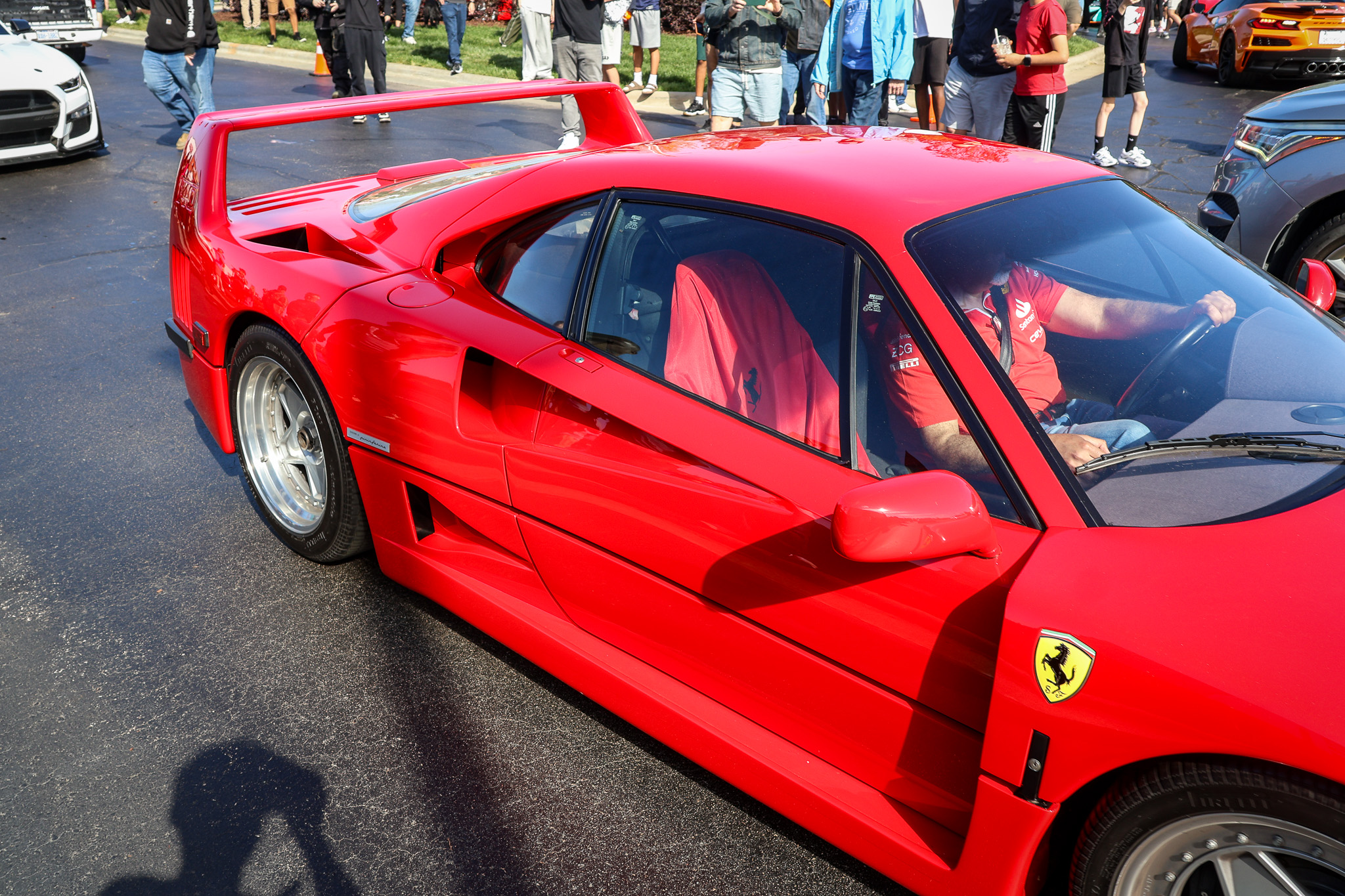 Ferrari F40 side profile view with driver visible in seat