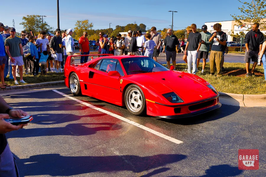 Ferrari F40 surrounded by spectators during Cars and Coffee Morrisville in North Carolina.