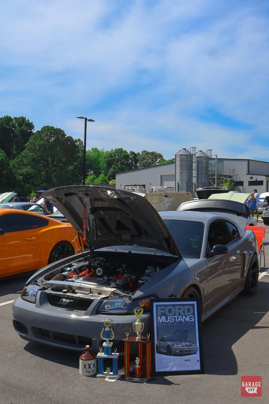 Engine bay of a modified Ford Mustang Mach 1 featuring a supercharged V8 at Fuquay-Varina Cars and Coffee.