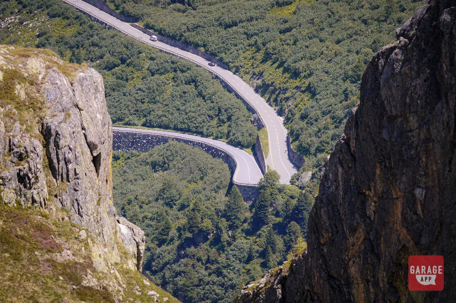 Furka Pass guardrail curves Swiss Alps driving road