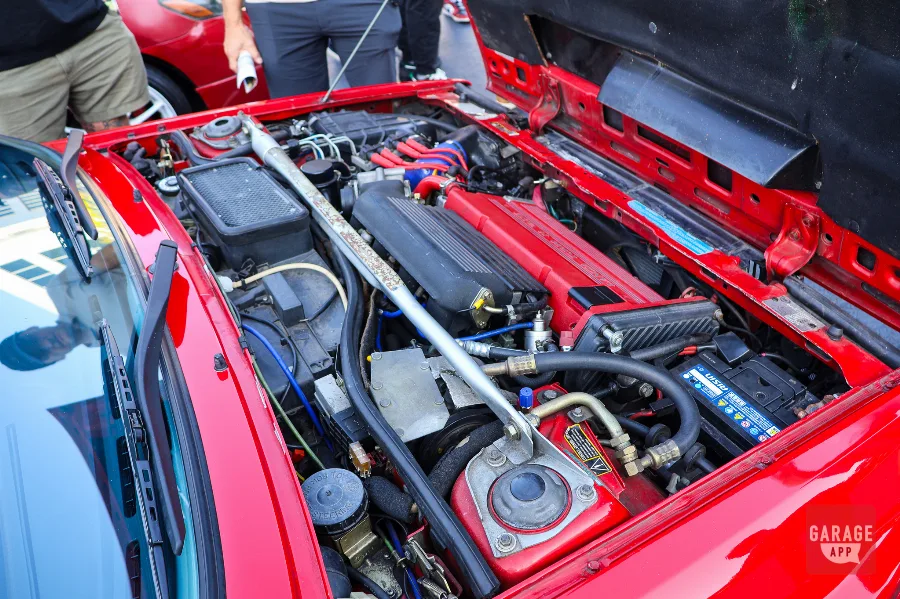 Lancia Delta HF Integrale engine bay with red cam cover and turbo