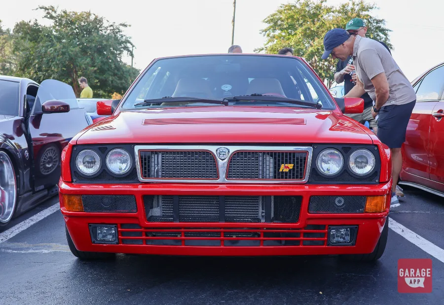 Red Lancia Delta HF Integrale front view with quad headlights and HF badge