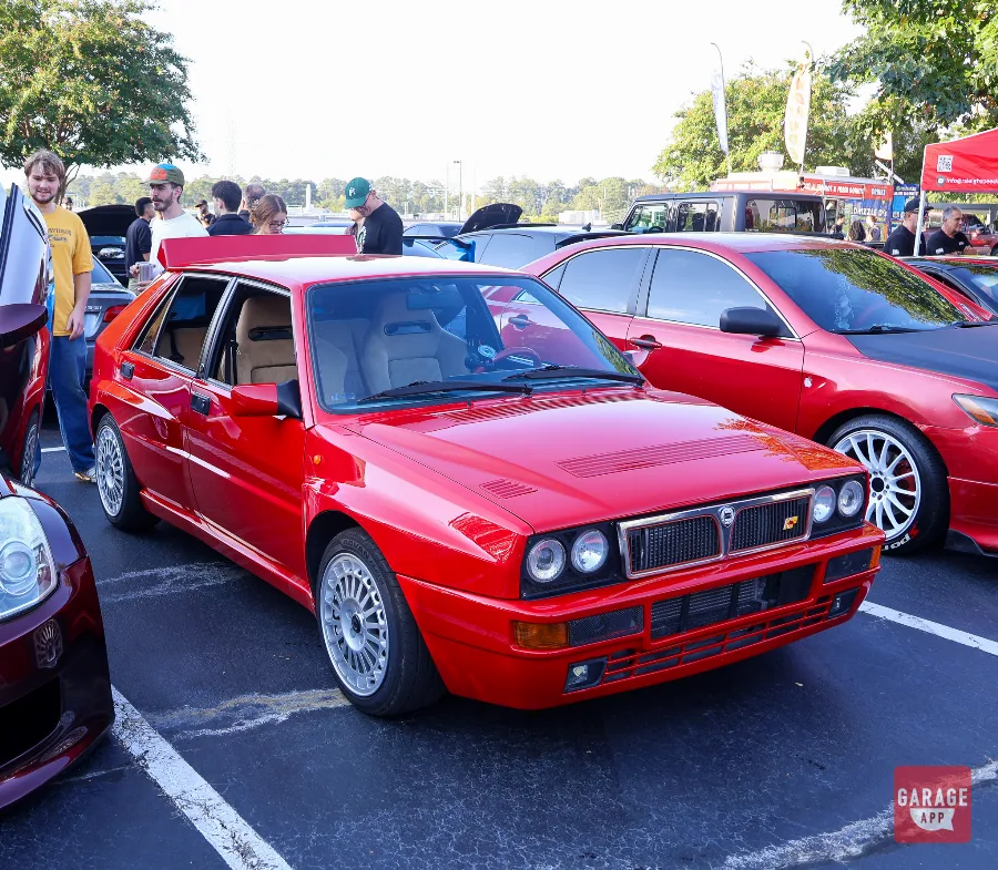 Red Lancia Delta HF Integrale front quarter view with spectators nearby