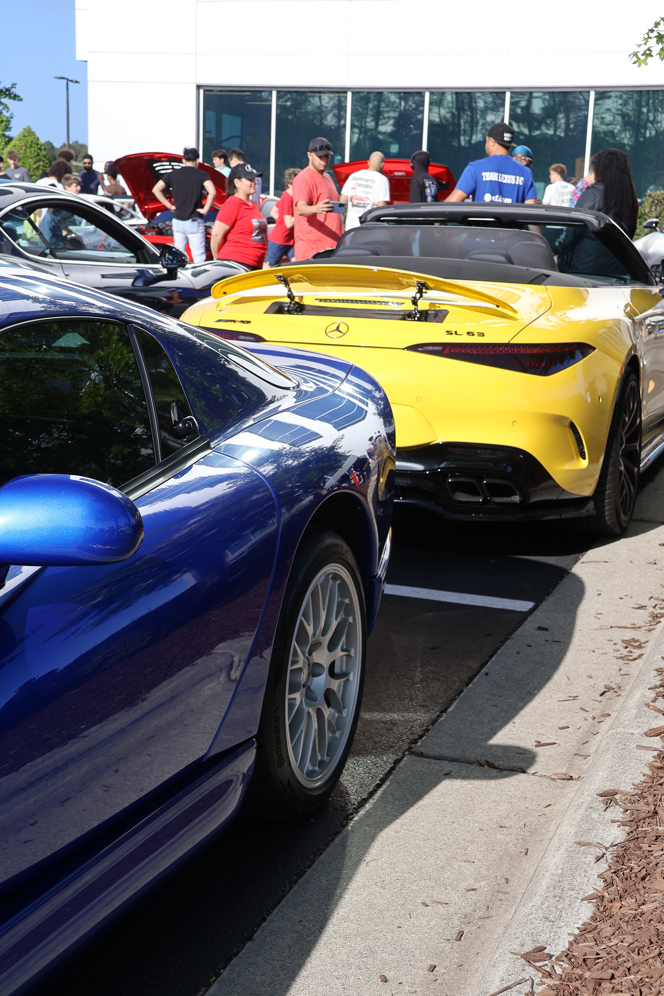 Yellow Mercedes-AMG SL63 rear view next to blue Dodge Viper