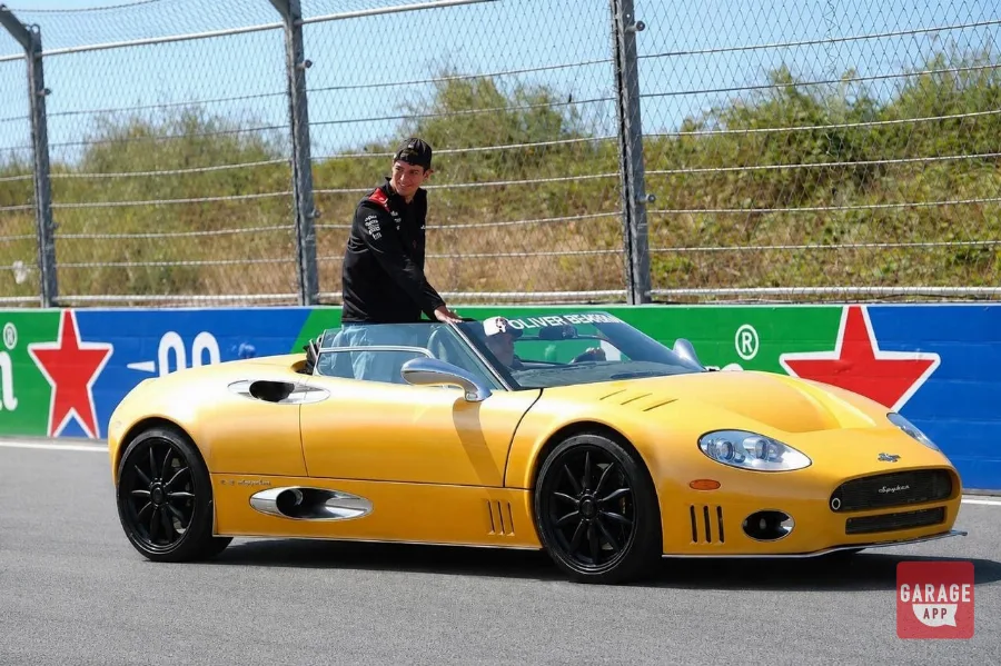 Oliver Bearman standing in yellow Spyker C8 during F1 Drivers' Parade at Zandvoort