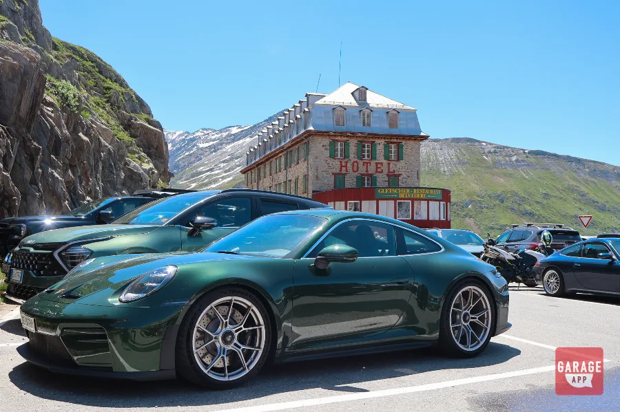 British Racing Green Porsche 911 GT3 parked at Hotel Belvedere on Furka Pass
