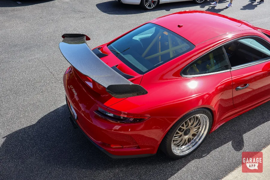 Overhead view of the Porsche 991.2 GT3 MR rear wing and roofline, showcasing Manthey Racing carbon fiber components and aerodynamic development.