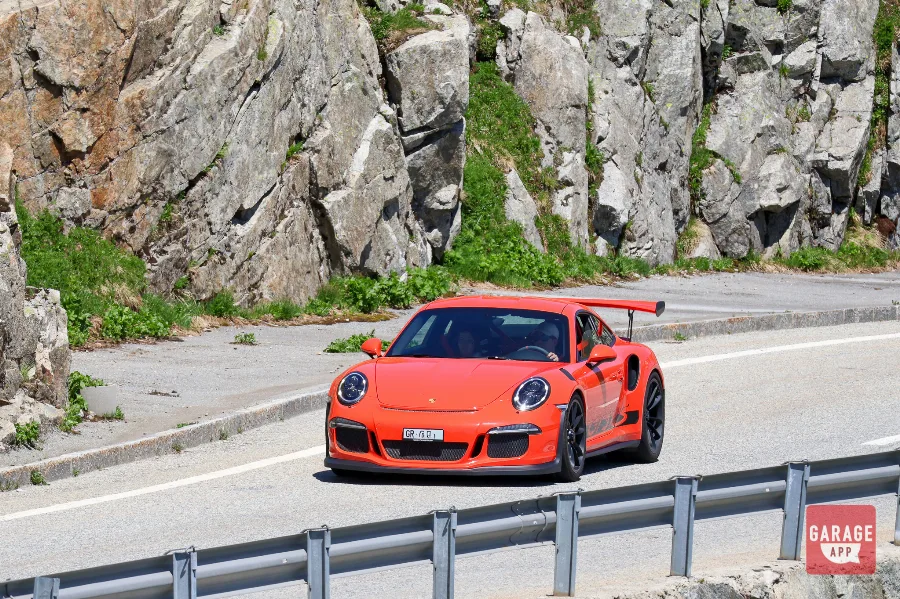 Orange Porsche 911 GT3 RS Furka Pass mountain road