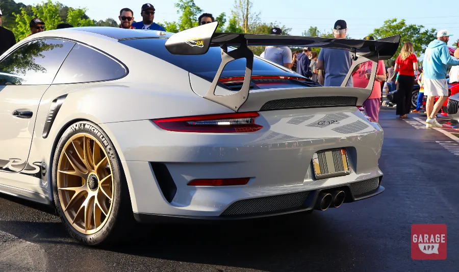 White Porsche 911 GT3 RS with gold wheels displayed at Cars and Coffee Morrisville.