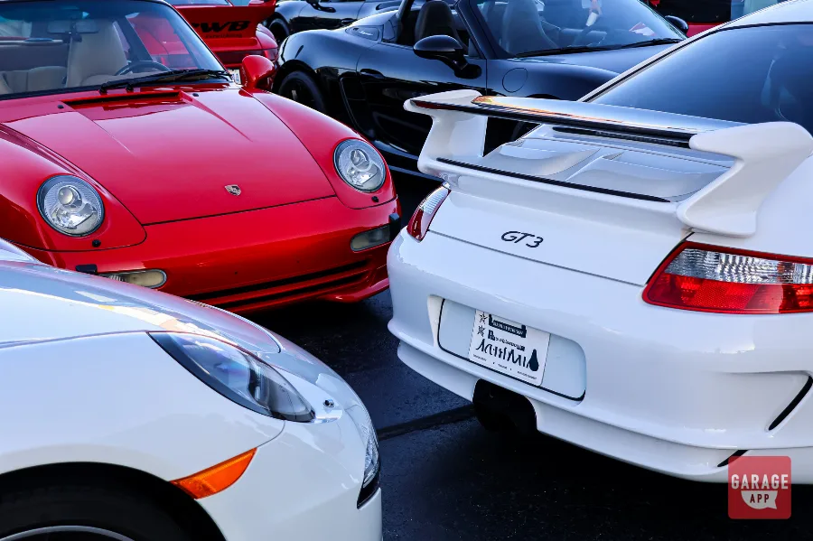 Multiple Porsche 911 models gathered together during Cars and Coffee Morrisville in Raleigh.