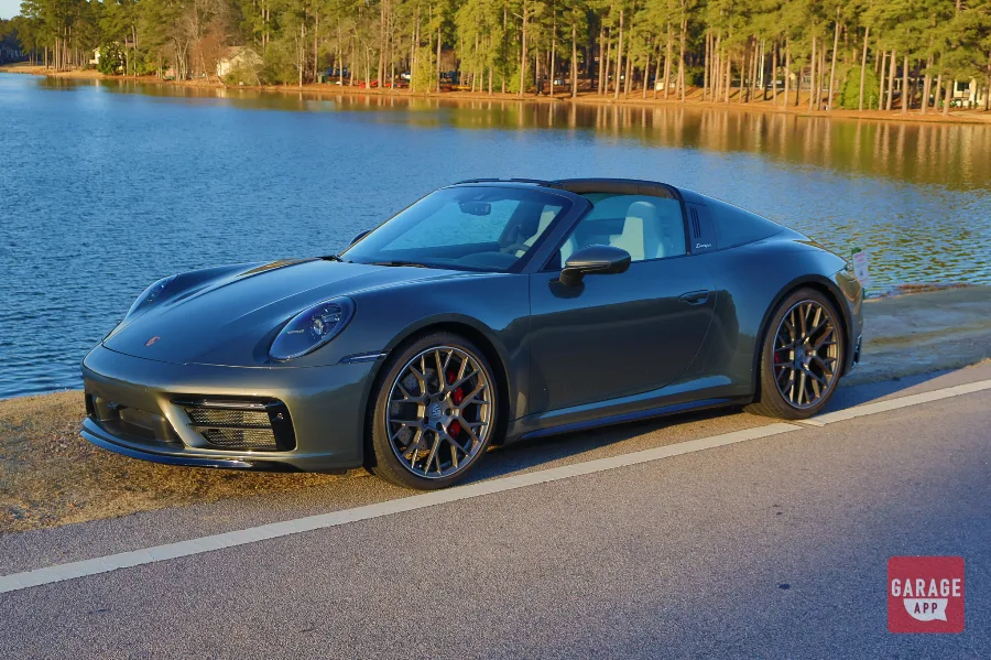 Front three-quarter view of a 992.1 Porsche 911 Targa 4S finished in Adventurine Green Metallic with the signature Targa roof and red brake calipers.