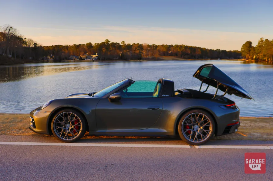 Automatic roof mechanism opening on a 992.1 Porsche 911 Targa 4S in Aventurine Green Metallic, demonstrating Porsche's iconic Targa system.