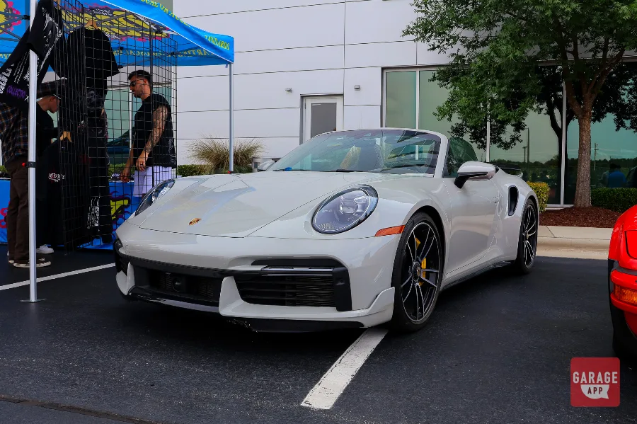 White Porsche 911 Turbo S Cabriolet front quarter view at car show