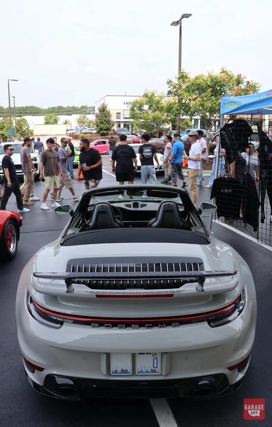White Porsche 911 Turbo S Cabriolet rear view with spoiler deployed at car meet