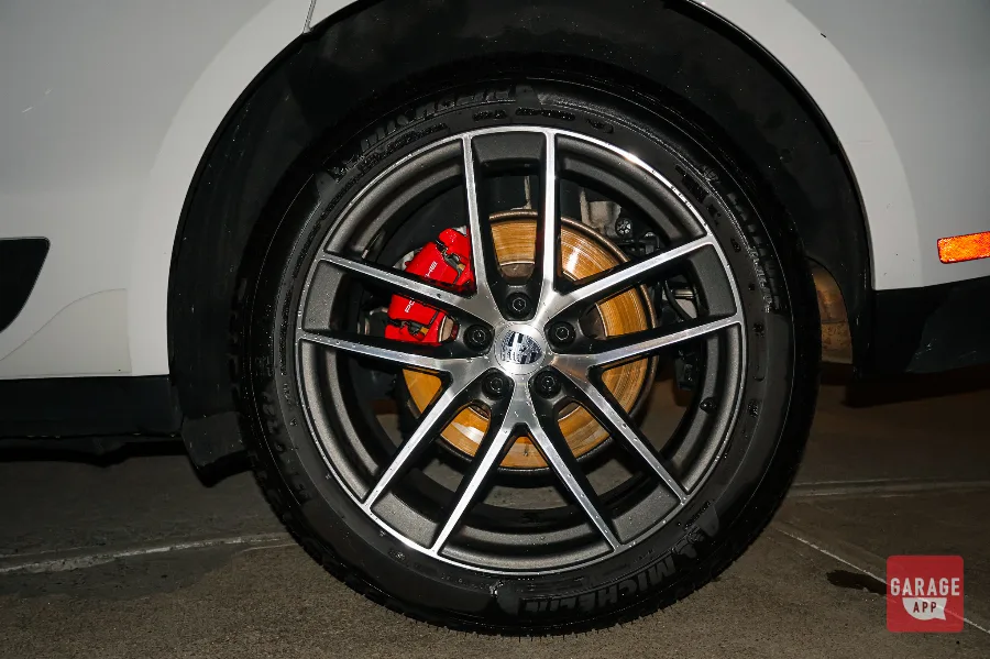 Porsche Macan S alloy wheel with red brake caliper and Michelin tire closeup