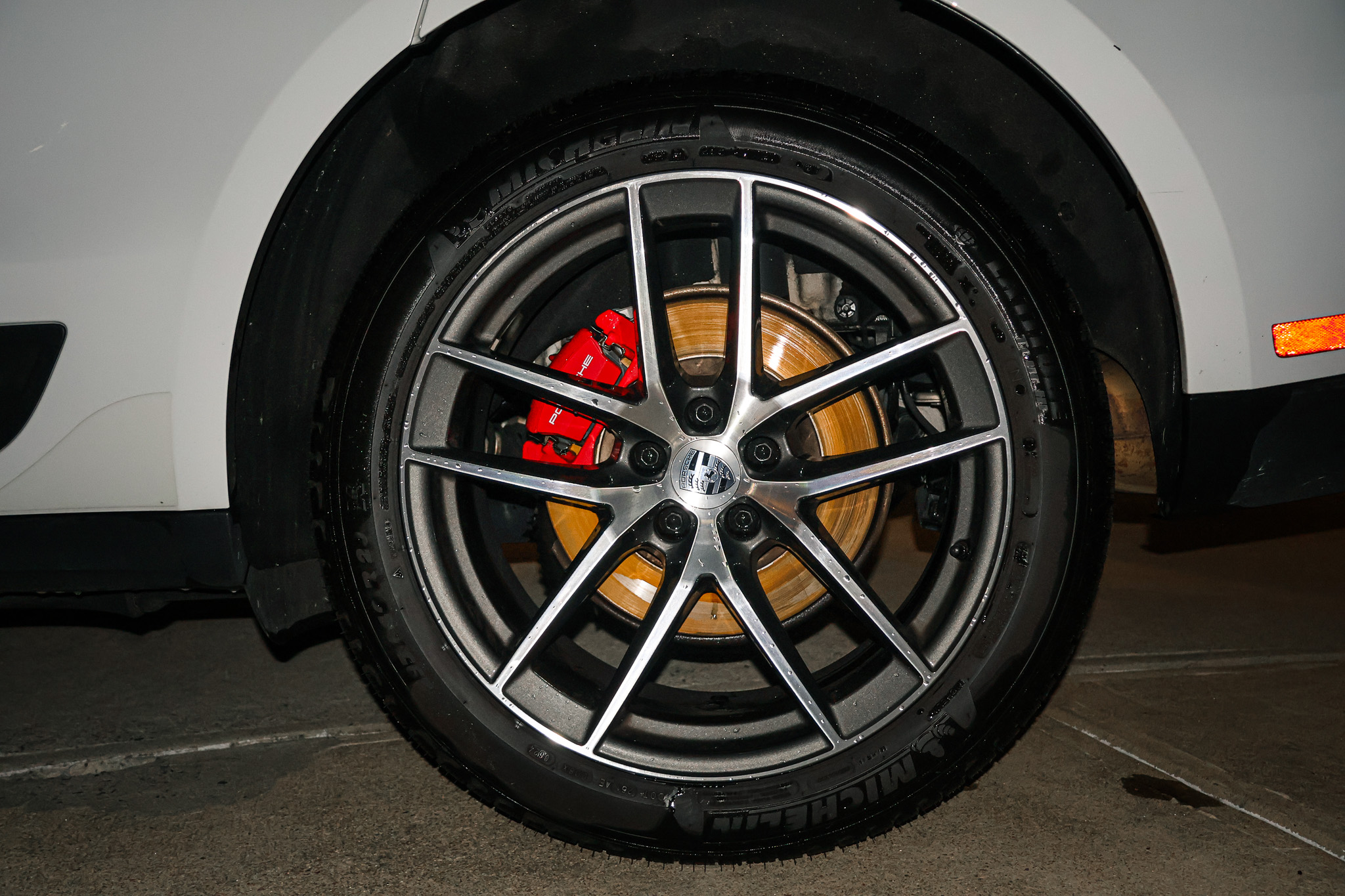 Porsche Macan S alloy wheel with red brake caliper and Michelin tire closeup