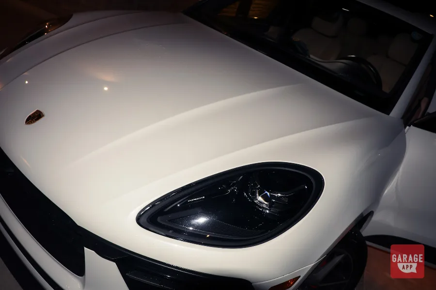 Porsche Macan S hood and headlight closeup with crest badge in white