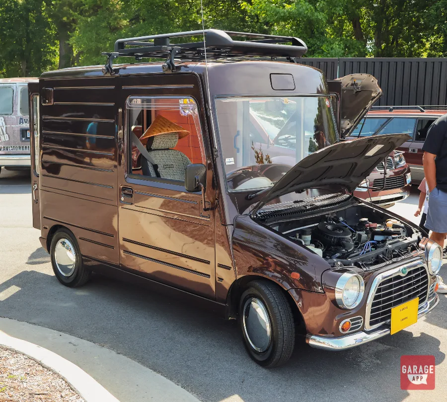 Restored classic Mini panel van with custom styling displayed at Fuquay-Varina Cars and Coffee.