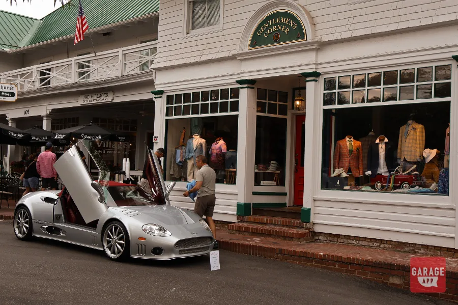 Silver Spyker C8 side profile doors up Pinehurst Village shop