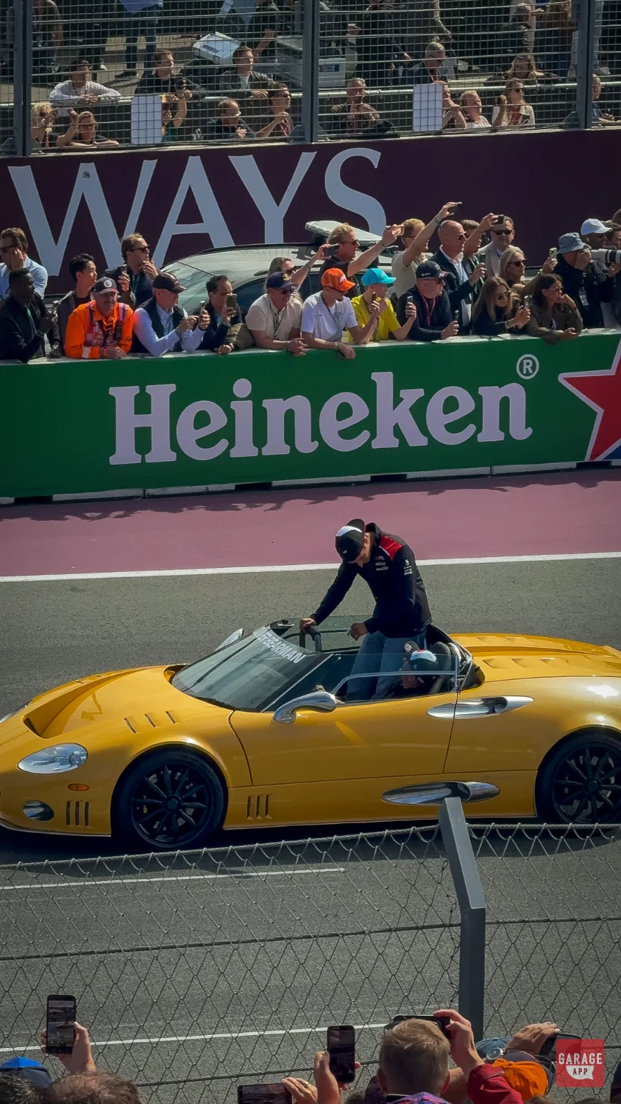 Yellow Spyker C8 with driver standing during Zandvoort F1 drivers parade