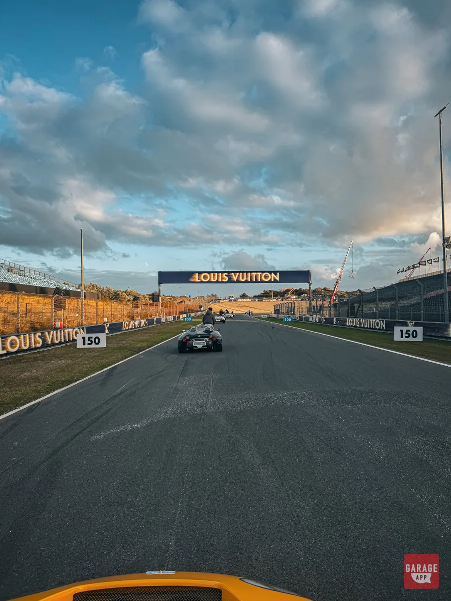 Spyker C8 parade cars driving under Louis Vuitton branded gantry at Zandvoort