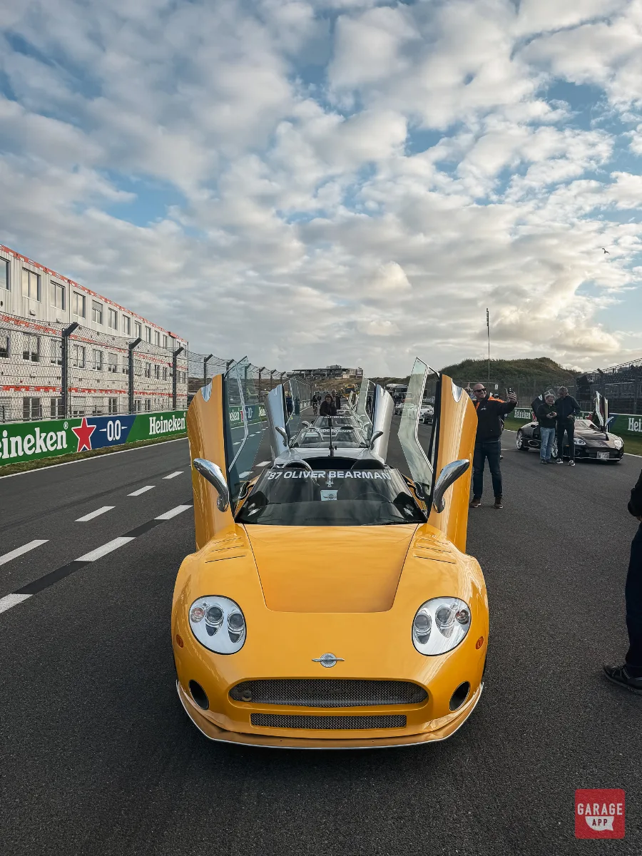 Yellow Spyker C8 with doors open marked for Oliver Bearman on Zandvoort straight