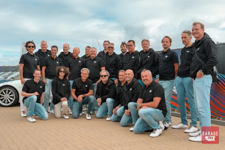 Group of Spyker C8 owners in matching black polos at Zandvoort F1 parade