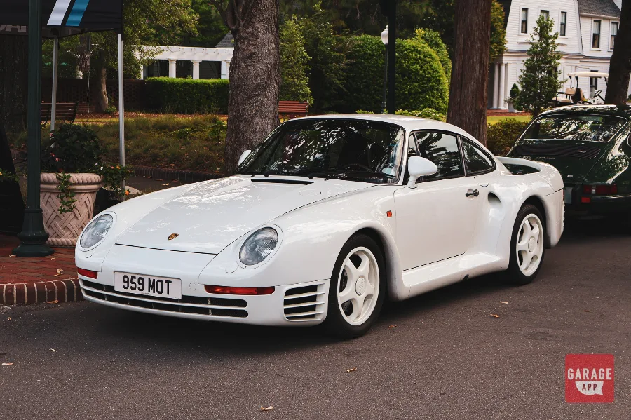 White Porsche 959 front three-quarter view displayed at Hagerty Cars & Caffeine in Pinehurst, showcasing one of Porsche's rarest twin-turbocharged collector supercars.