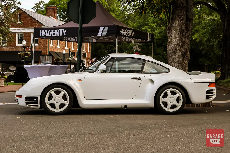 Porsche 959 supercar on display at a collector car event, showcasing one of Porsche's most historically significant vehicles.